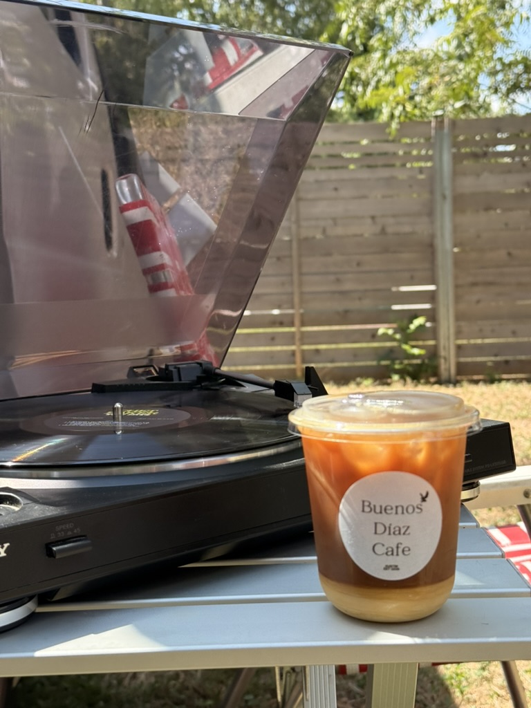 Iced coffee next to a turntable